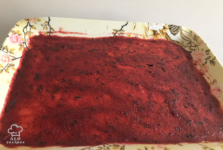 Plum puree in a greased tray