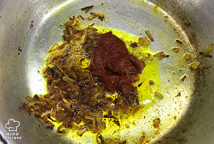 Add the tomato paste, salt, pepper, and turmeric