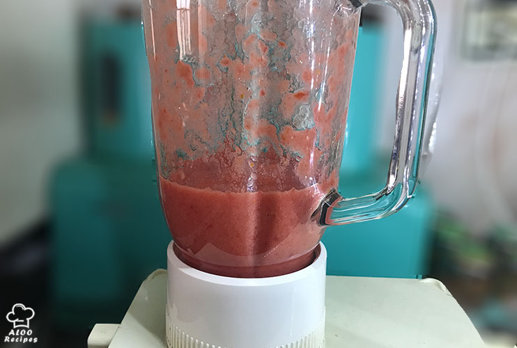 Pour tomatoes in a blender